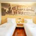 Citihub Hotel @Pecindilan Surabaya room with two single beds and Colosseum wall mural