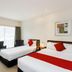 Fitzherbert Regency Motor Lodge in Palmerston North guest room with two beds, red accents, and large window