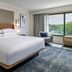 Sheraton Nashville Brentwood guest room with king bed, armchair, and large window view in Brentwood