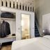 B&B HOTEL Rouen Parc des Expos Zénith room with bed, open wardrobe, loft stairs and city-view window