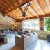 Montanya Hotel & Lodge in Seva lounge with stone walls, wood-beam ceiling, and sofas by large window