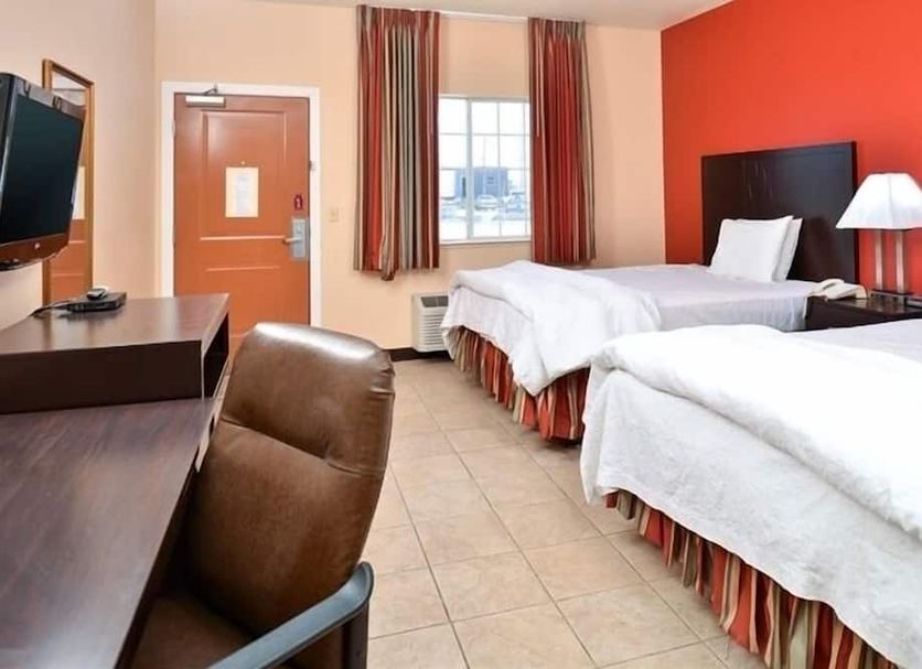 La Bonita Inn & Suites - McCamey room with two beds, desk, TV and window view