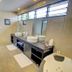 Nila Beach Resort, Lautoka bathroom with double sinks, bathtub, large mirror and window light