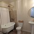 Hotel Leger bathroom in Mokelumne Hill with clawfoot tub, pedestal sink and vintage rug
