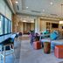 Home2 Suites by Hilton Orlando at FLAMINGO CROSSINGS Town Center lobby with seating, bar stools and lounge area in Bay Lake