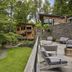 Woodstock Way Hotel in Woodstock with a landscaped courtyard, stone terrace seating, and wooded cabin views