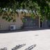 Nestor in Zacháro: ground-floor hotel terrace with large concrete patio and tree shade