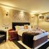 Muthu Ben Doran Hotel, Crianlarich: elegant guest room with bed, armchair, bedside table and wall sconces