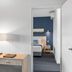 The Barn Accommodation Mount Gambier guest room with desk and lamp, looking into bedroom