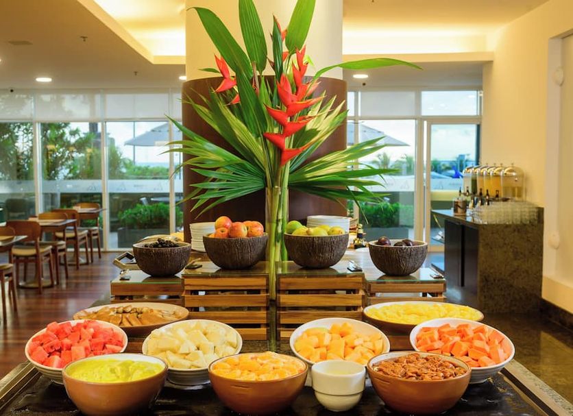 Hotel Luzeiros Fortaleza breakfast buffet with tropical flowers and fruit in Fortaleza