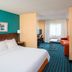Fairfield Inn & Suites by Marriott South Bend Mishawaka guest room with bed, TV and sitting area in Mishawaka