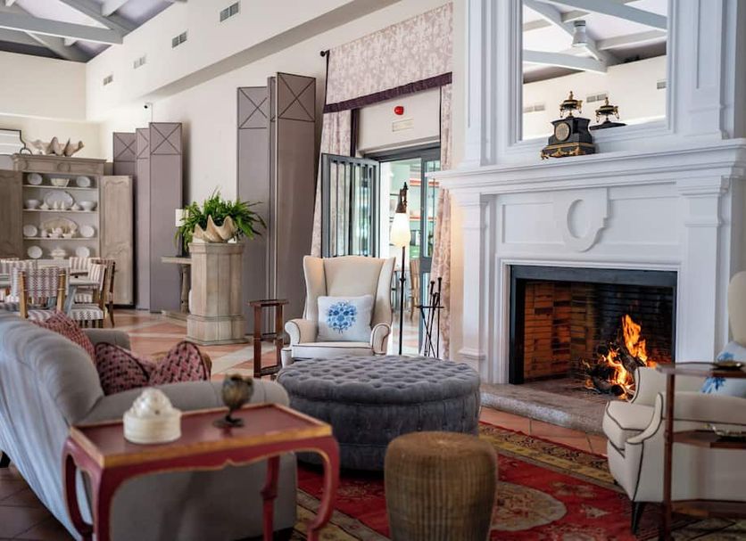 Azz Castellar Hacienda El Alcornocal lounge with fireplace and seating in Castellar de la Frontera