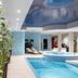 Crowne Plaza Vilnius indoor spa pool with mosaic hot tub and lounge chairs in Vilnius
