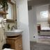 Oasis Lagoon Estate Venice bathroom with vessel sink, wall-mounted hair dryer and view into a bedroom