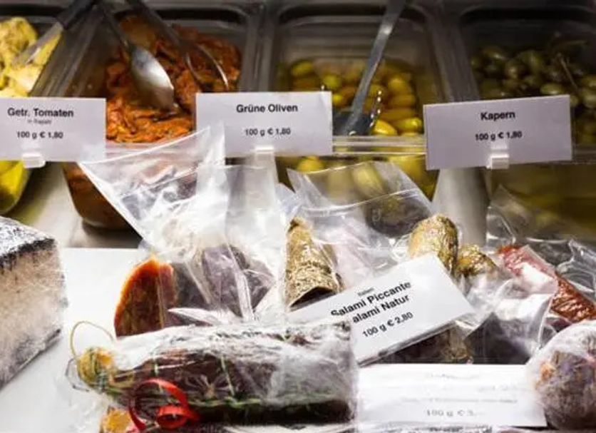 Hotel Vinothek Schwarzer Adler in Ottensheim displays olives, capers, tomatoes and packaged salami.