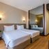 Nova Cruz Hotel in Santa Maria da Feira room with twin beds, mirrored wall and wood flooring