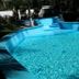 Mansion Giahn Bed & Breakfast in Cancún with a curved outdoor pool surrounded by tropical greenery