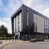 Travelodge Hull Central in Hull, modern hotel exterior on a street corner with parked cars