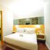 Citihub Hotel @Pecindilan Surabaya guest room with double bed, wood floor, and mirrored wall