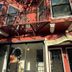Twin Peaks Hotel in San Francisco, brick exterior with fire escape and ornate entrance awning