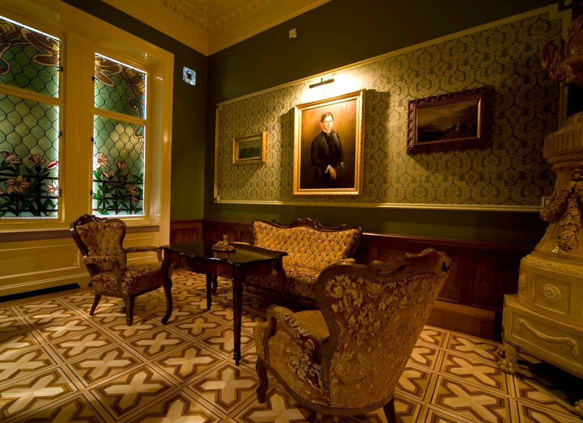 Boutique Hotel Victoria Budapest lounge with ornate seating, portrait, and patterned tile floor in Budapest
