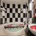 Somadevi Angkor Premium in Siem Reap bathroom with rose-petal bath and vessel sink
