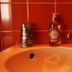 Next Inn, Portimão bathroom sink with soap dispenser, faucet and red tiled wall