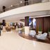 Blue Tree Towers Caxias do Sul lobby with curved mezzanine, lounge seating and dining area