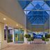Holiday Inn Express Pensacola Beach lobby with glass ceiling and ocean view beyond