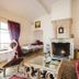 Le Palais d'Aglaé, Hôtel de Charme in Gordes: elegant lounge with ornate fireplace and patterned armchairs