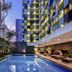 Grand Mercure Jakarta Harmoni in Jakarta with outdoor pool and illuminated hotel facade