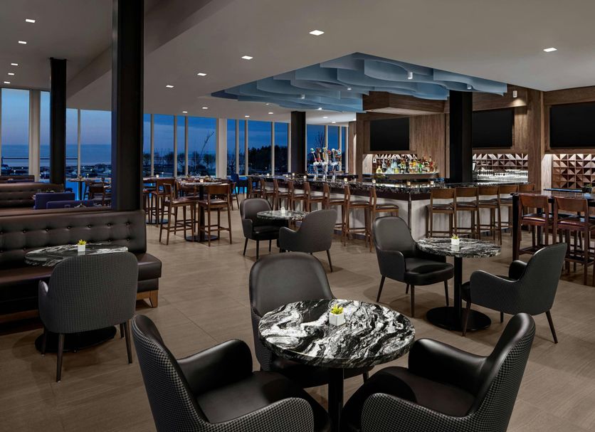 Delta Hotels by Marriott Thunder Bay lounge bar with lake view and city skyline at dusk