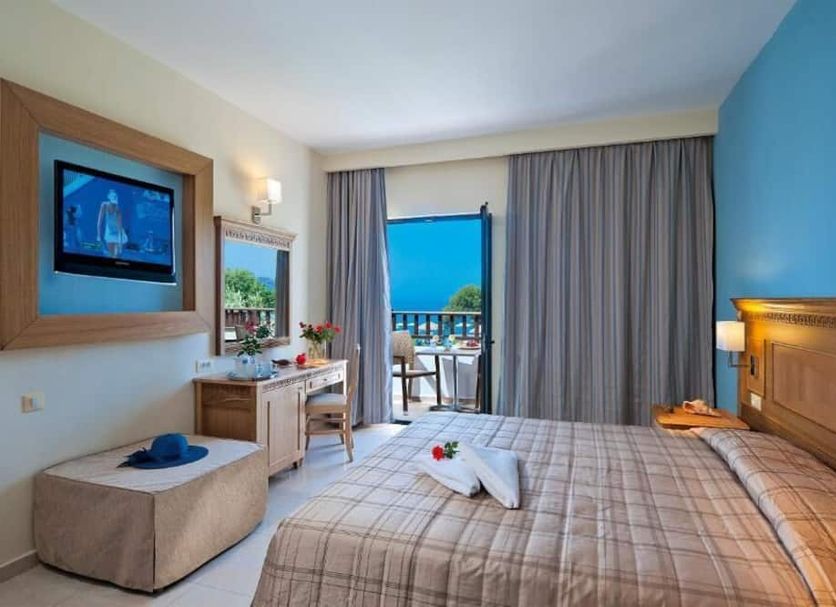 Geraniotis Hotel And Resort in Chania guest room with balcony sea view and sliding glass door