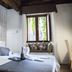 Do-Do Navona Suites in Rome: cozy room with bed, window seat, and soft natural light