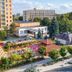 Hotel Barátság in Hajdúszoboszló with outdoor terrace, garden seating, and multi-story hotel buildings