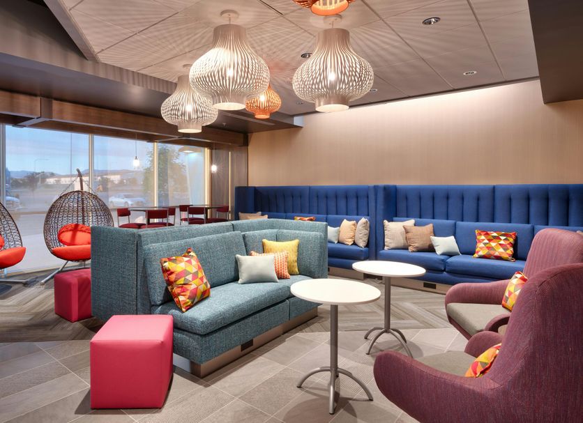 Tru by Hilton Clearfield Hill Air Force Base lobby lounge with colorful seating and hanging chairs in Clearfield