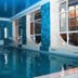 Indoor pool at Safir Hotel in Dushanbe with tall windows and blue mosaic walls