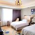Ramada Plaza by Wyndham Tian Lu Hotel Wuhan room with two twin beds, window light and floral artwork