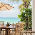 Cheval Blanc St-Barth in Gustavia: beachfront dining table with umbrella and ocean view