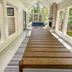 Ruttger's Bay Lake Resort in Deerwood: screened porch with long wooden dining table, sofa, and stone fireplace