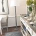 Oude Berg Guesthouse George entryway with console table, floor lamp, flowers, and glass pitchers