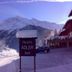 Hotel Meublè Adler sign in Santa Caterina Valfurva with snow-covered mountains and road