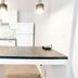 Lincoln Inn Fredericton kitchen with white cabinets, refrigerator, and central island