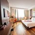 Van Phat Riverside Hotel in Can Tho guest room with king bed, river-view window, and modern wood flooring