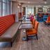 Hampton Inn Orlando-Maingate South in Davenport lobby lounge with colorful chairs and tables