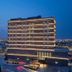 Four Points by Sheraton Ciudad Juarez hotel exterior at dusk with city lights and illuminated facade