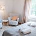 Backby Manor in Espoo guest room with two armchairs, floor lamp, bedside table and bed by windows