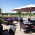 Europa Kehl Hotel outdoor terrace with tables, chairs, and large umbrellas in Kehl