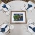 Elkwater Lake Lodge And Resort, Elkwater: round banquet table set with plates, blue napkins, and framed centerpiece