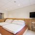 Guanwu Villa in Tai'an Township bedroom with multiple beds, wall-mounted TV and window view